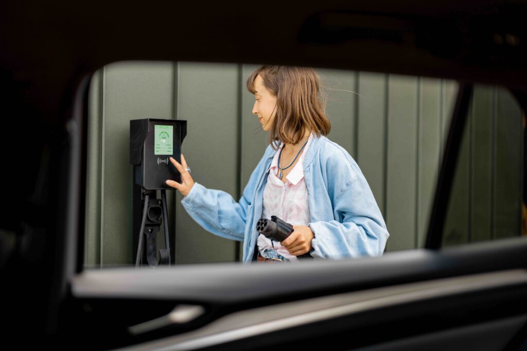 ev 1 woman charging electric car with charging station tulum playa del carmen